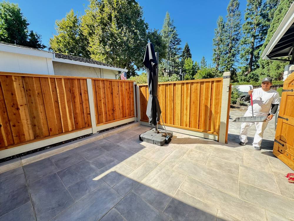 Crew finishing a patio and cedar fence installation