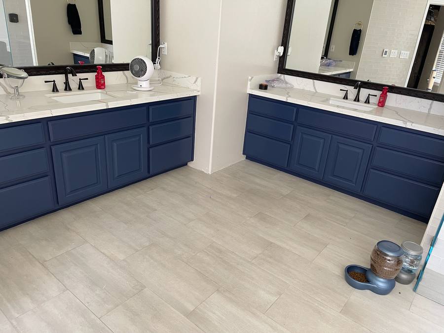 Double vanity with matte navy blue cabinets after refinishing