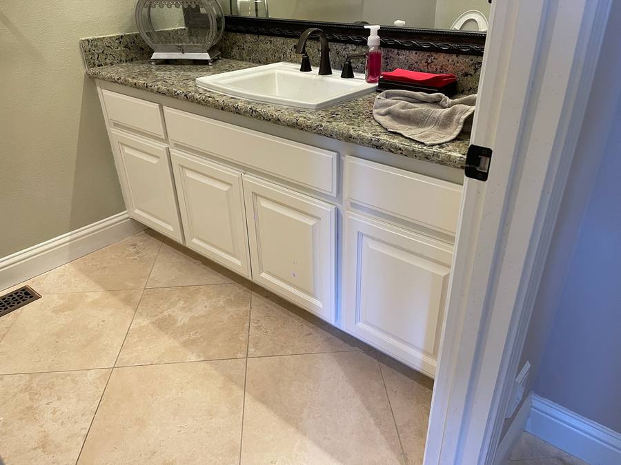 Bathroom vanity with white cabinet after refinishing